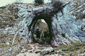 Natural Rock Archway on Hiking Trail in Forest