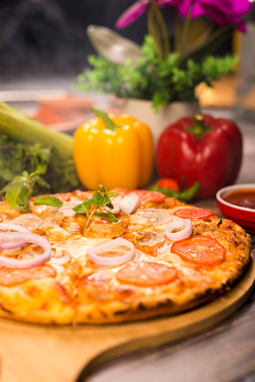 Delicious pepperoni pizza with fresh vegetables on wooden board