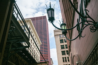 Low angle view of urban architecture with vintage street lamp