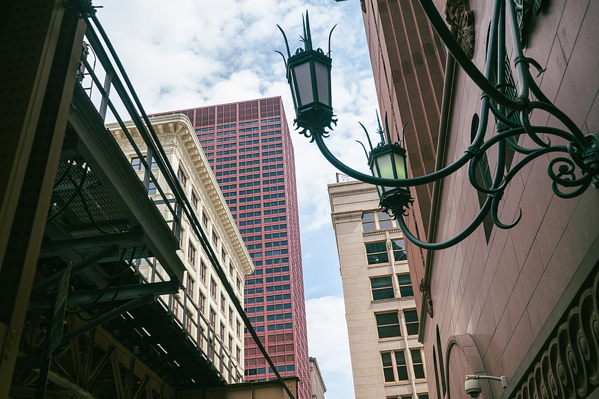 Low angle view of urban architecture with vintage street lamp
