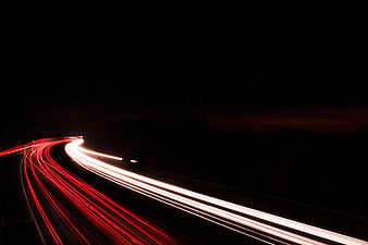 Long exposure light trails on a dark highway at night