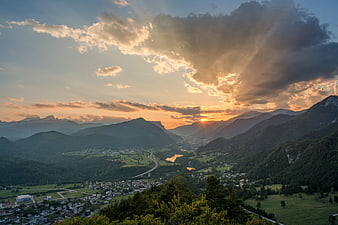 Dramatic Sunset Over Mountain Valley with Sunbeams