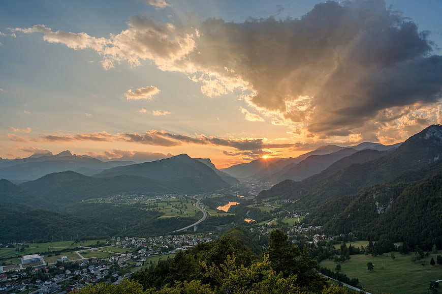 Dramatic Sunset Over Mountain Valley with Sunbeams