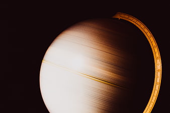 Close-up of vintage globe with dramatic lighting