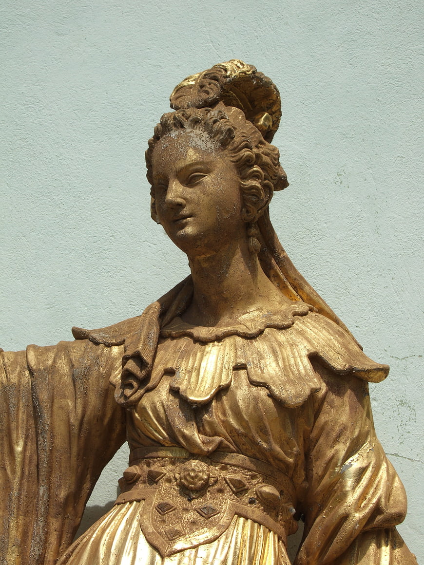 Golden Statue of a Woman in Historical Costume