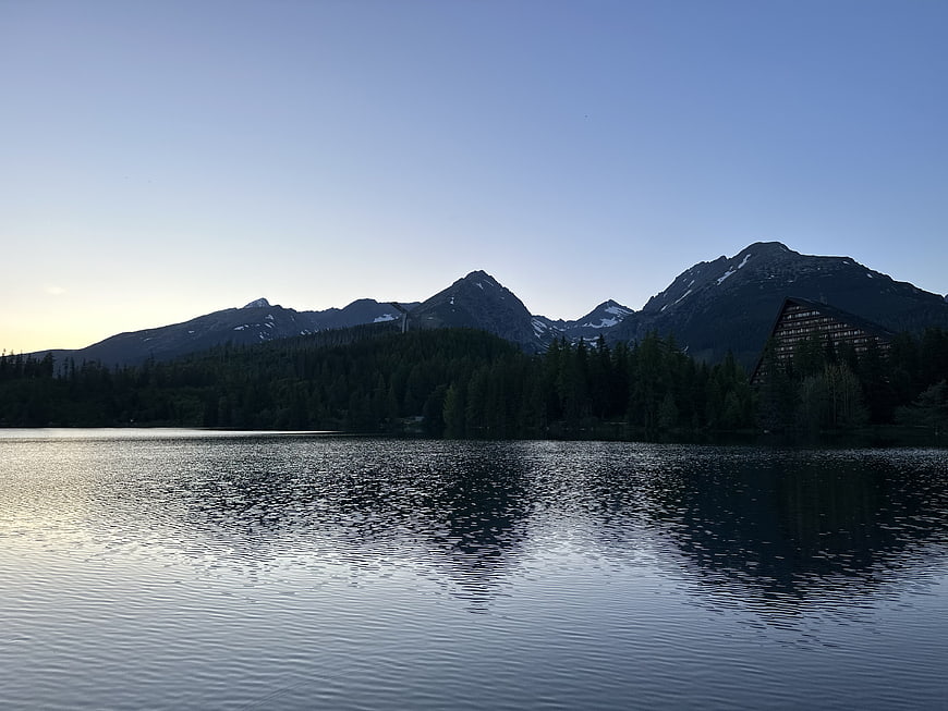 Serene Mountain Lake Landscape with Cabin Reflection at Dusk
