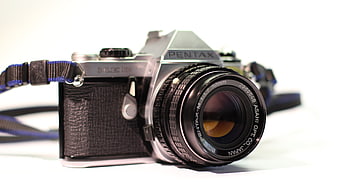 Vintage Pentax SLR Camera With 50mm Lens On White Background