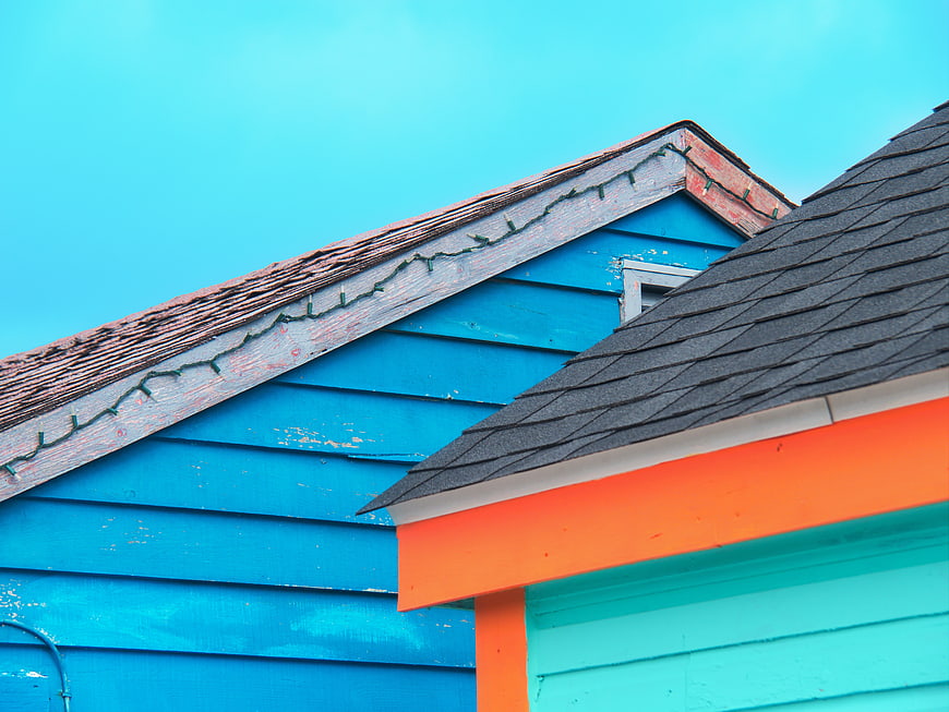Colorful House Roof Peak with Blue Sky Background
