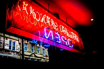 Glowing Red and Blue Neon Open Sign at Night