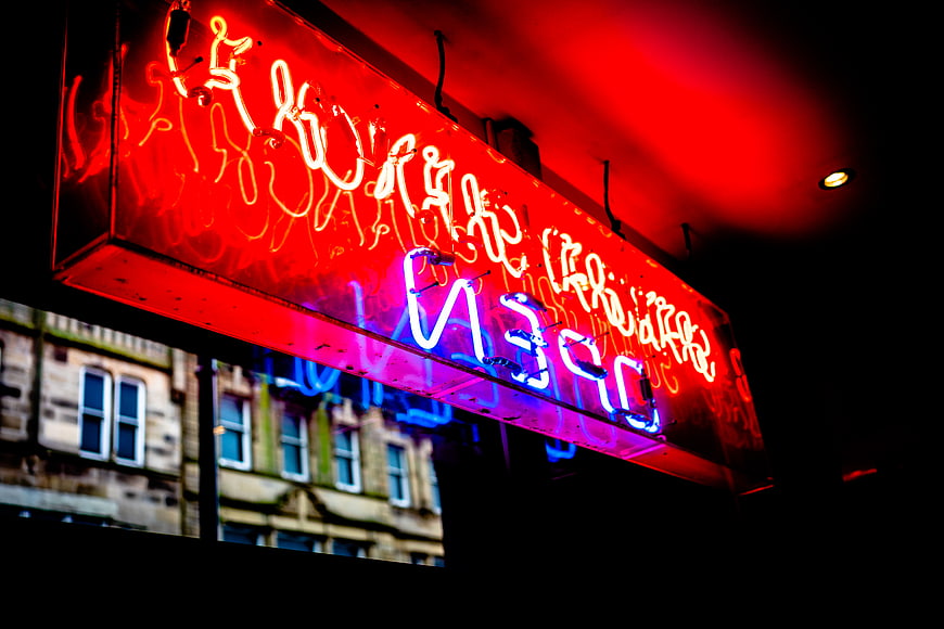 Glowing Red and Blue Neon Open Sign at Night
