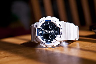 White G-Shock Watch on Wooden Table
