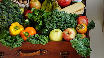 Vintage suitcase overflowing with fresh fruits and vegetables