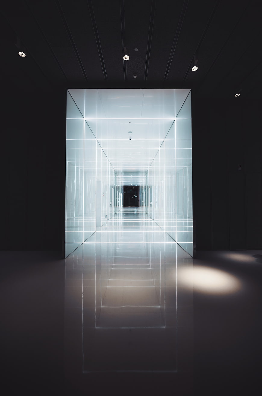Futuristic illuminated glass corridor with neon grid lines