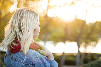 Blonde Woman in Denim Jacket Looking at Golden Sunset