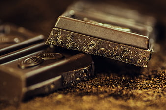 Close-up of dark chocolate bar with cocoa powder texture