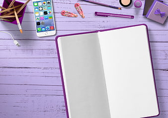 Purple flat lay with open notebook, smartphone, and stationery on wooden desk