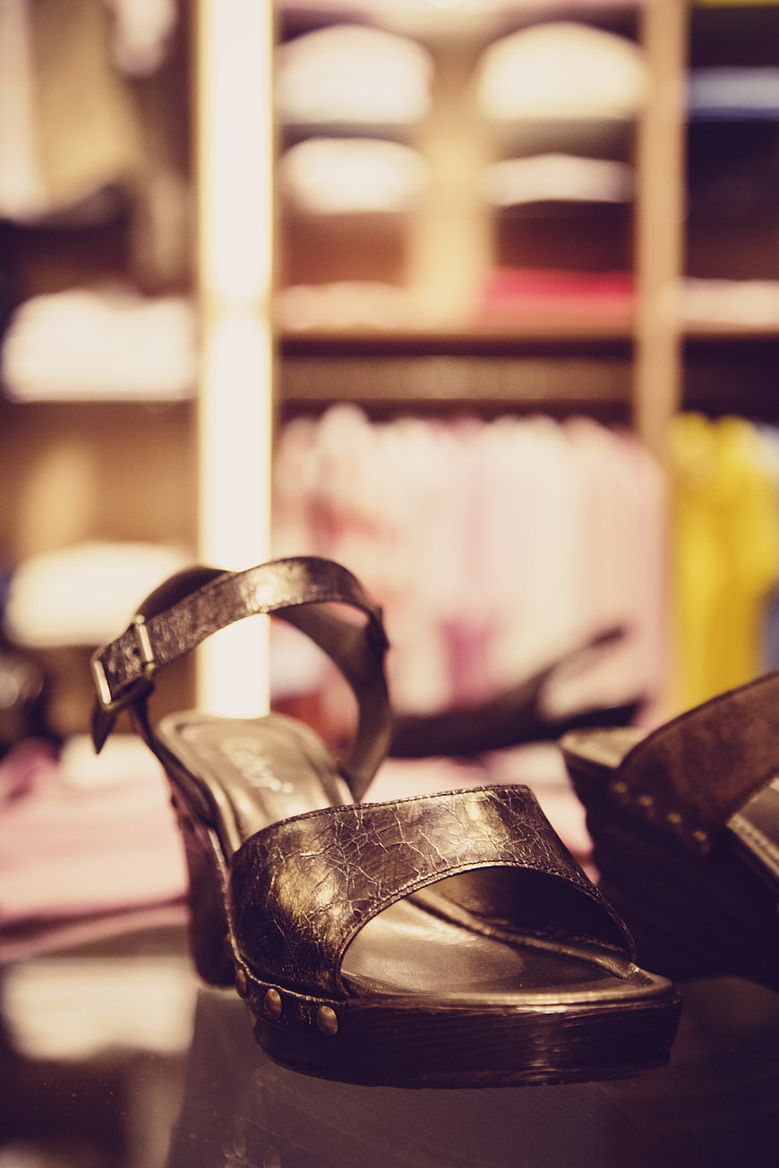 Close-up of metallic gold wedge sandals in boutique