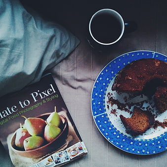 Flat lay of coffee, cake, and food photography book