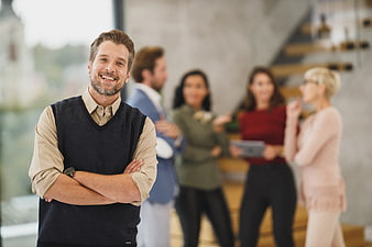 Smiling Businessman with Team in Modern Office