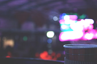 Blurred Night City Lights with Coffee Cup Foreground