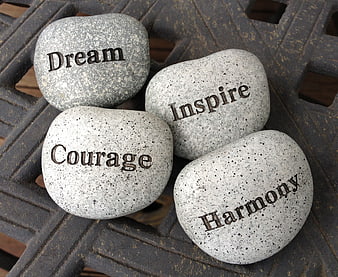 Inspirational stones with words dream, inspire, courage, harmony