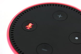 Close-up of Amazon Echo Dot with glowing red microphone button