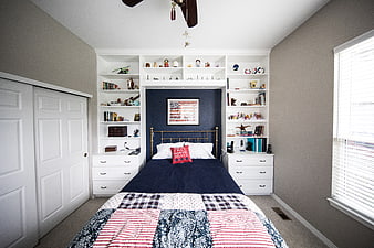 Modern Bedroom with Navy Accent Wall and White Built-in Shelving
