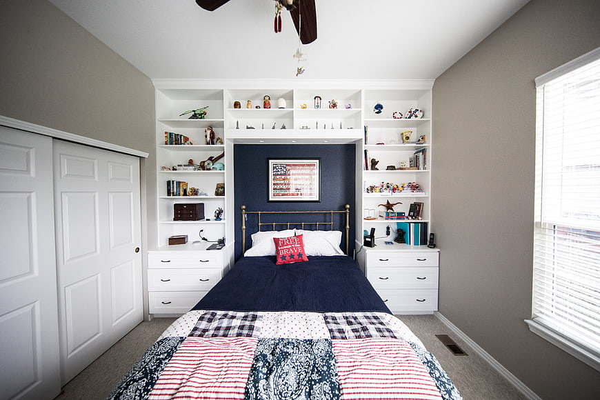 Modern Bedroom with Navy Accent Wall and White Built-in Shelving