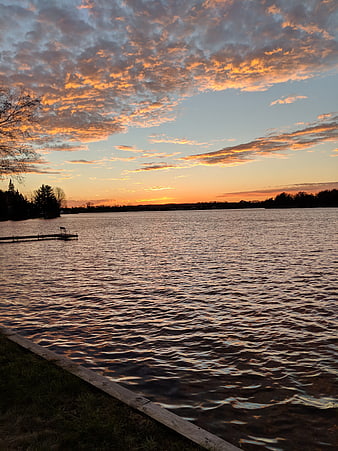Serene Lake Sunset with Golden Clouds and Wooden Dock