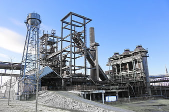 Industrial steel mill complex with water tower and smokestacks