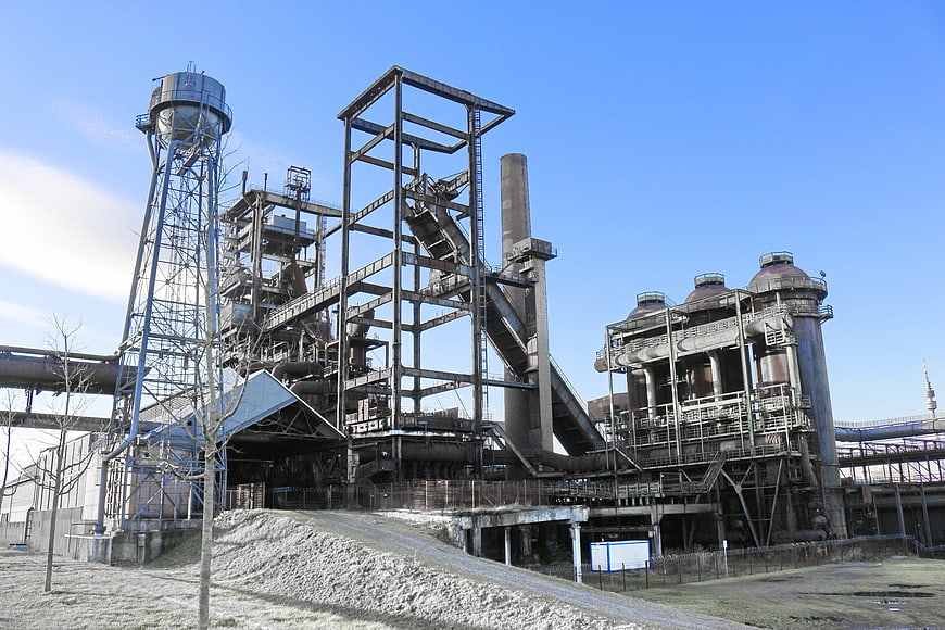 Industrial steel mill complex with water tower and smokestacks