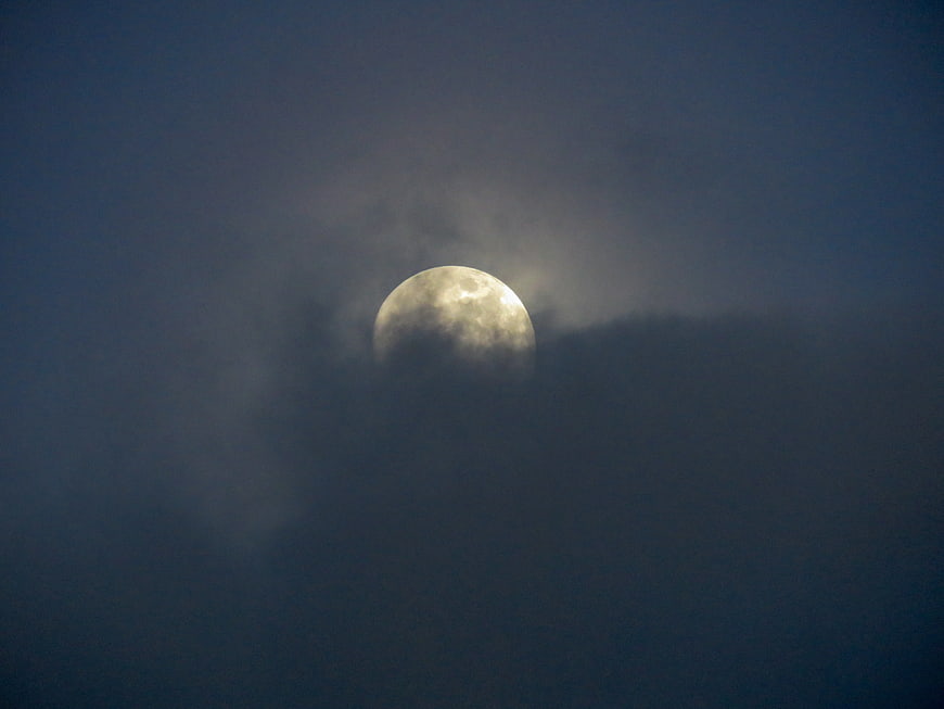 Full Moon Partially Obscured by Dark Clouds at Night