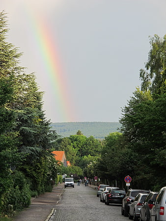 Vibrant Rainbow Over Cobblestone Street in German Town