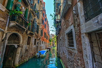 Narrow Venice Canal with Colorful Buildings and Moored Boat