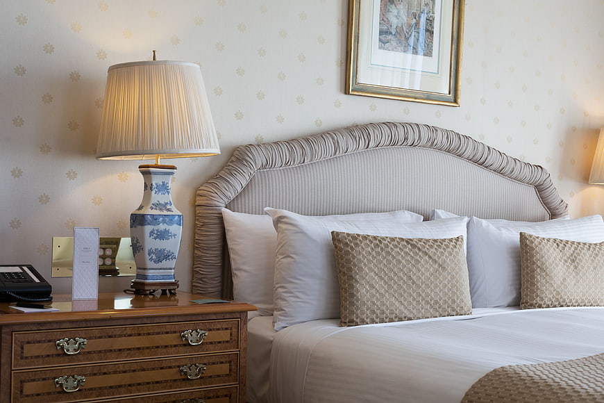 Luxurious Hotel Bedroom Interior With Elegant Bed And Nightstand