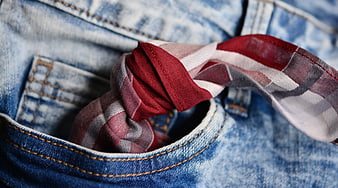 Red plaid handkerchief tucked in denim pocket