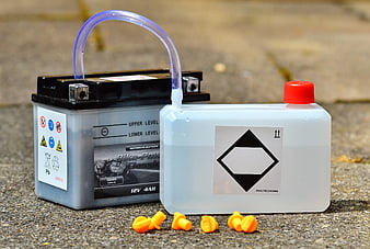 Motorcycle battery maintenance with acid and funnel