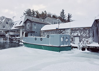 Frozen Harbor with Boat and Snowy Buildings