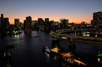 Tokyo Bay Twilight Skyline With Rainbow Bridge And Illuminated Boats