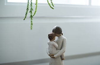 Ceramic mother and child figurine with hanging greenery