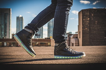 Person Walking in LED Light-Up Sneakers on Urban Rooftop