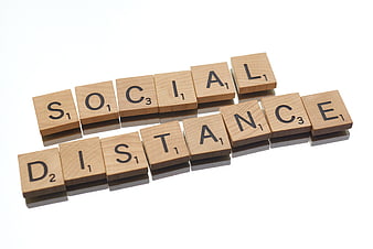 Wooden Scrabble Tiles Spelling Social Distance on White Background