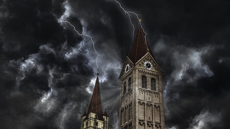Dramatic lightning striking church tower in storm