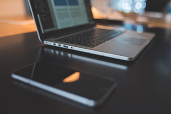 Laptop and Smartphone on Dark Desk Workspace