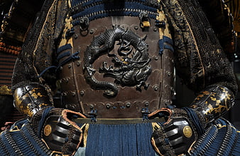 Close-up of ornate samurai armor with dragon emblem