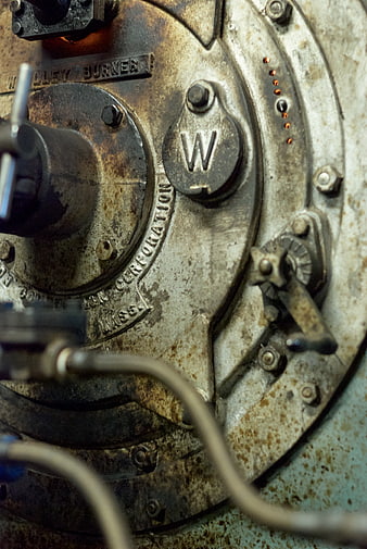 Close-up of rusty industrial boiler burner plate
