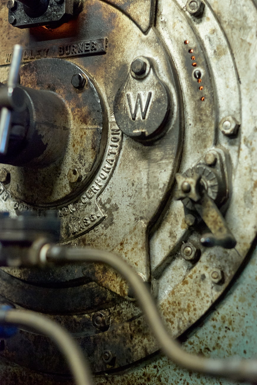 Close-up of rusty industrial boiler burner plate
