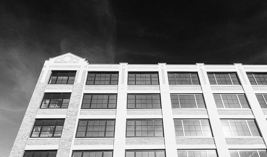 Black and white low angle view of modern office building facade