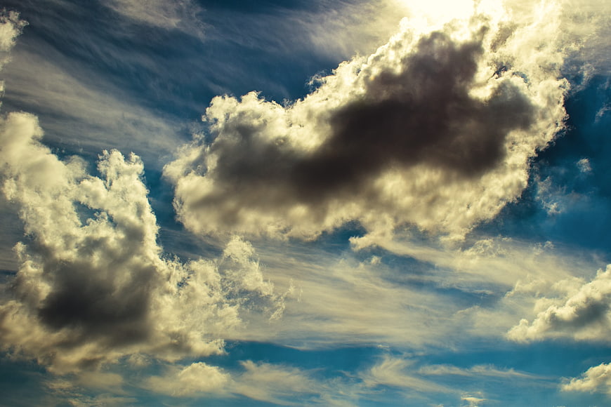 Dramatic Sunlit Clouds in Blue Sky