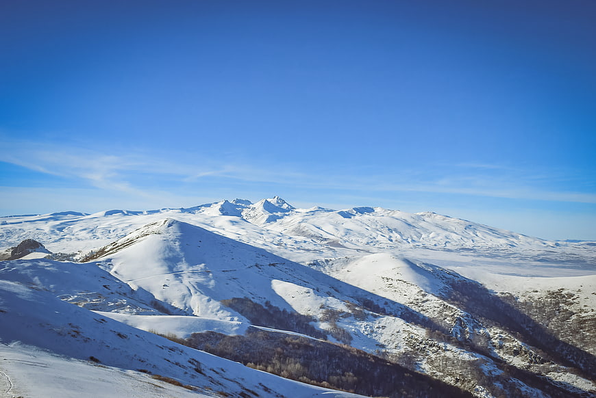 Snow-covered mountain range under a clear blue sky